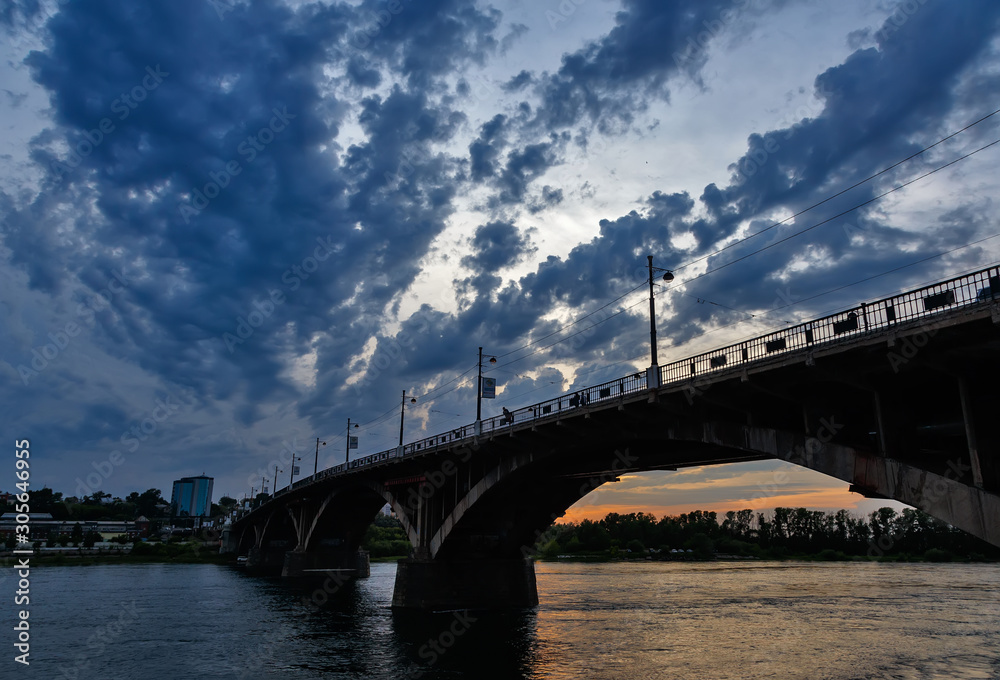 Bridge over Angara river in Irkutsk city after sunset wtih blue clouds