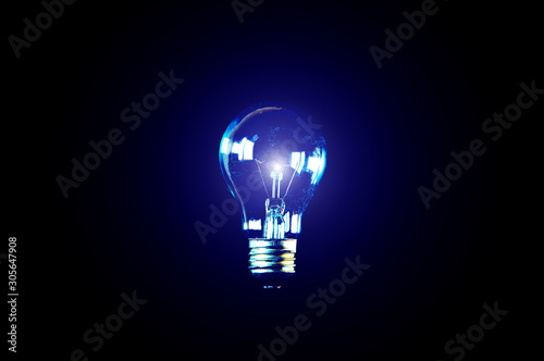 Lamp bulb on black background. Map inside. New idea concept.