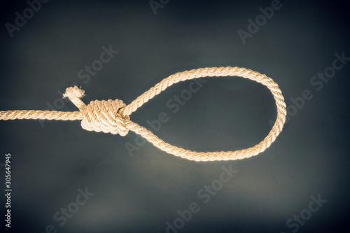 Noose on black background. Suicide concept. Hanging because of work stress. Depression of burnout. Terrible life situation.