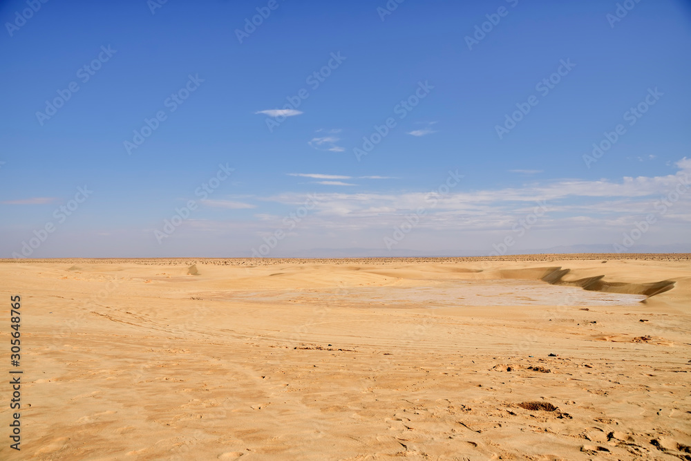 boundless expanses of the Sahara desert, a plot of solanchak against the backdrop of a desert landscap