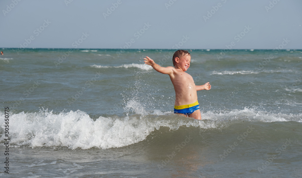 Children swim in the sea on the beach in Bibione, Italy Children swim in the sea on the beach in Bibione, Italy