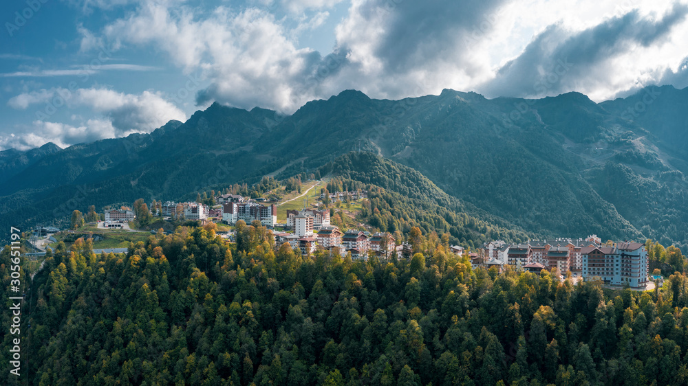 Aerial view; drone photo of hotels buildings and ski resorts of Rosa Plateau alpine mountain olympic village; beautiful summer landscape, mounts and valleys terrain; popular touristic route