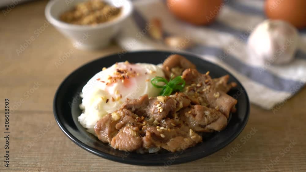 stir-fried pork with garlic on topped rice with egg - asian food style stir-fried pork with garlic on topped rice with egg - asian food style