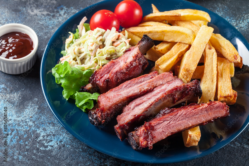 Spicy barbecued pork ribs served with french fries