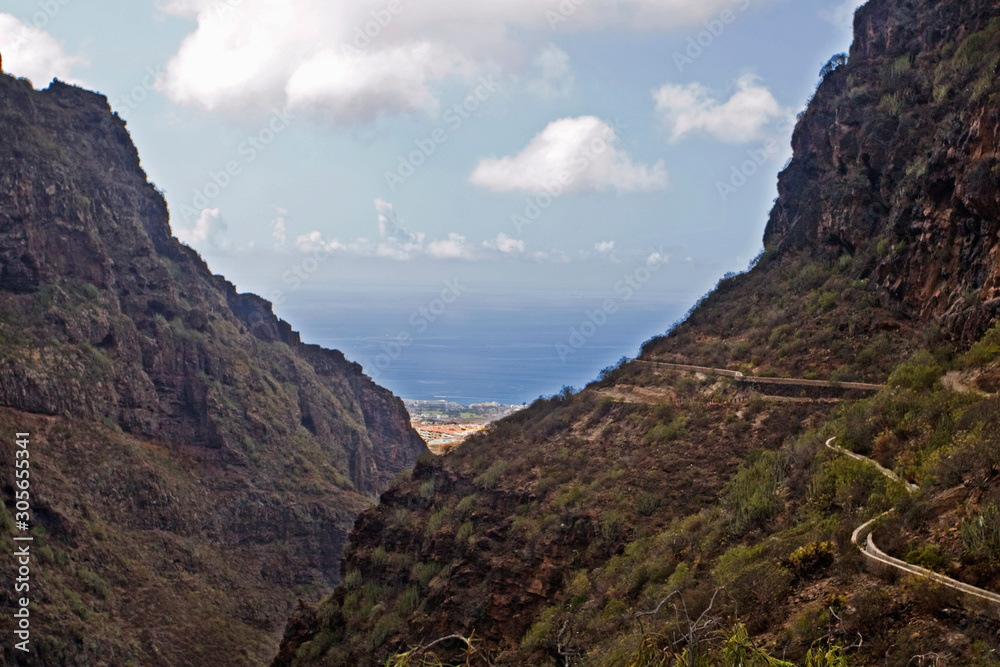 mountain trail through the gorge of the oxamite mountain and the sea to the mysterious waterfall on the island of Tenerife, natural background