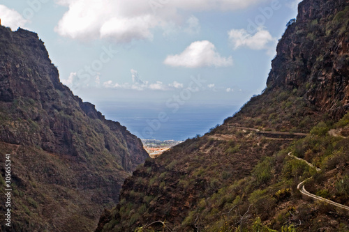 mountain trail through the gorge of the oxamite mountain and the sea to the mysterious waterfall on the island of Tenerife, natural background © Nataliia Makarovska