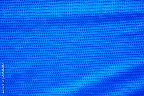 Blue football jersey clothing fabric texture sports wear background, close up top view