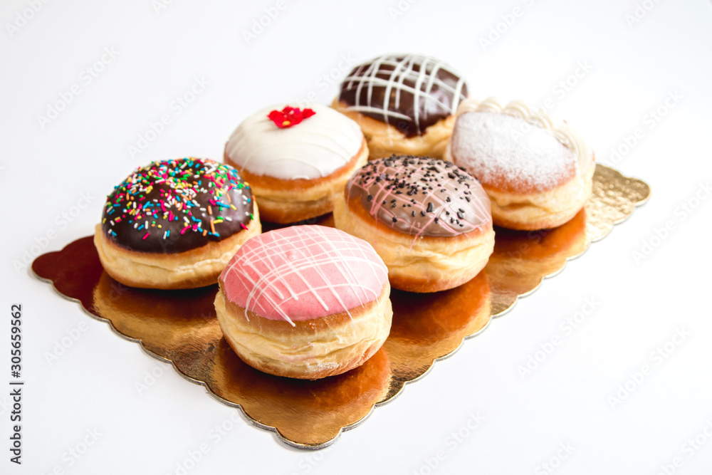Group of fresh decorated doughtnuts on one plate Group of fresh decorated doughtnuts on one plate