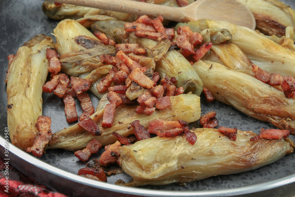 braised endives with bacon in a dish braised endives with bacon in a dish