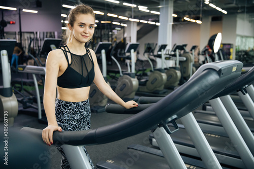 Young sports girls do fitness, lifestyle, sports and healthy eating, in the gym girls do exercises, jogging on the track