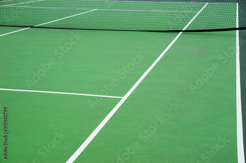 Fotografie View of a green tennis court. Side line of the tennis court