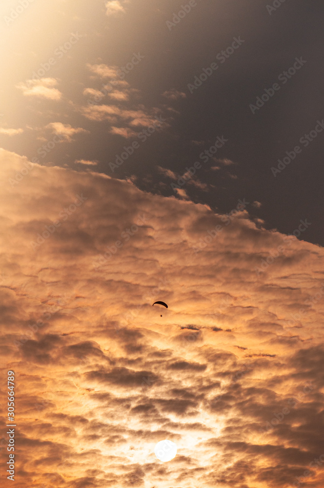 Paraglider in the clouds at sunset Paraglider in the clouds at sunset