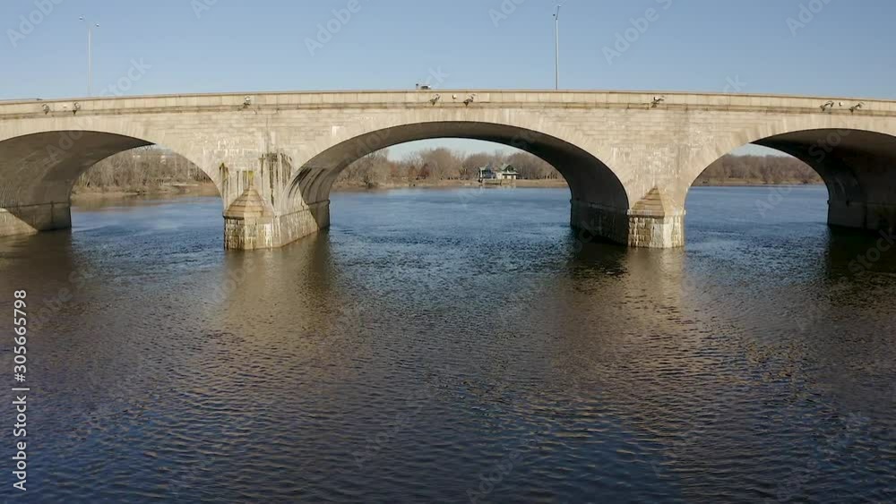 Aerial drone flying under brick bridge on Connecticut River on a sunny day Aerial drone flying under brick bridge on Connecticut River on a sunny day