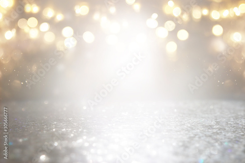 abstract background of glitter vintage lights . silver, gold and white. de-focused