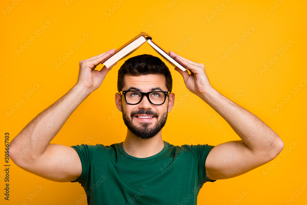 Close up photo of cheerful brunet hair guy put paper book above head look creative reading concept to memorize information wear spectacles modern clothing isolated bright color background Close up photo of cheerful brunet hair guy put paper book above head look creative reading concept to memorize information wear spectacles modern clothing isolated bright color background