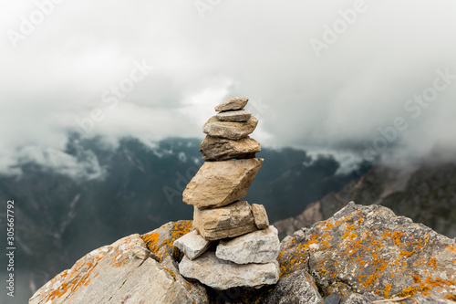 stack of stones on background of blue sky and clouds