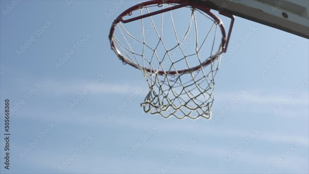 ball flies into the basket. Streetball. Basketball. Slow motion ball flies into the basket. Streetball. Basketball. Slow motion