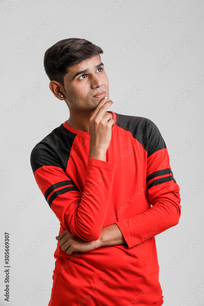 Indian / Asian man in red T-shirt and showing multi pal expression over white background t]