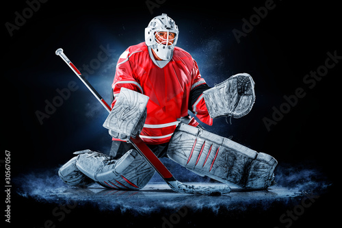 Professional ice hockey goalkeeper or goalie or goaltender isolated on black backgroung