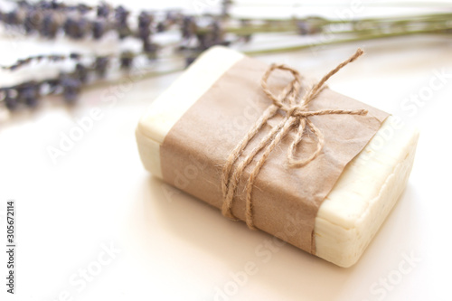 Handmade soap in focus with dry lavender flowers on a white isolated background. Spa design concept. View from above. Close-up.