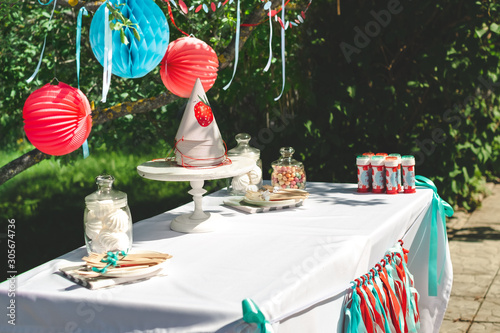 Preparing for the holiday and decorating the garden with balls and colored ribbons. Children's birthday party outdoor garden