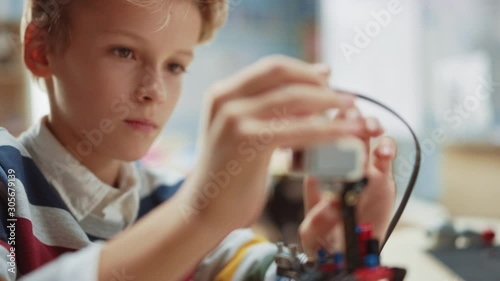 Wallpaper Mural Schoolboy Builds / Constructs Small Robot and Uses Laptop to Program Software for Robotics Engineering Class. Elementary School Science Classroom with Gifted Brilliant Children Working with Technology Torontodigital.ca