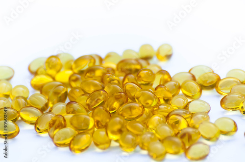 Vitamin D pills on a white background close-up.Yellow pills isolated with a place for inscription.Nutritional supplements.