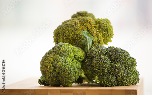 fresh brocoli on wooden board in the kitchen table