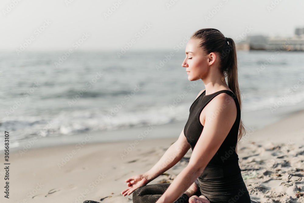 beautiful woman meditating and practice yoga on the beach near ocean beautiful woman meditating and practice yoga on the beach near ocean