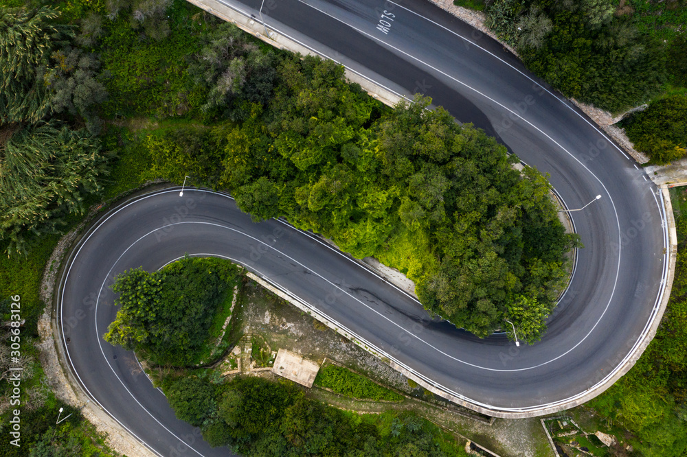 Curves road in Mellieha city. Aerial view. No cars. Clean highway. Malta island Curves road in Mellieha city. Aerial view. No cars. Clean highway. Malta island