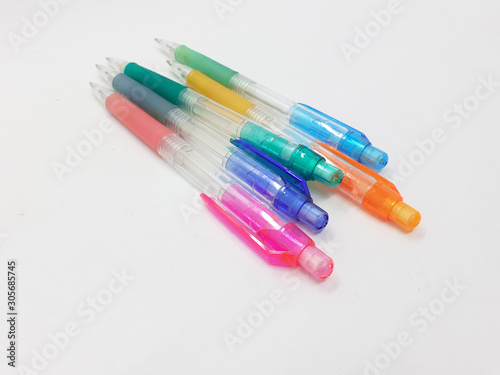 Hand Holding Colorful Artistic Pens for Coloring and Drawing Tools in White Isolated Background