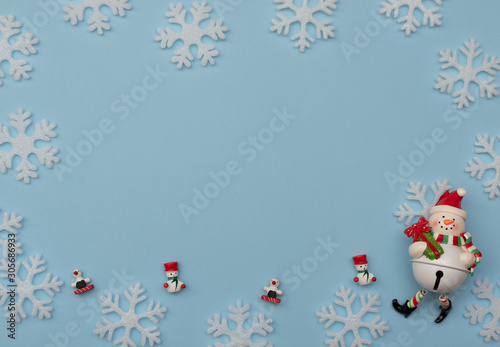Christmas blue background with Christmas decorations and white snowflakes. New Year greeting card. Flat lay style. 