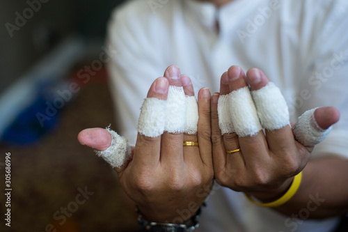 Man finger wrapped in white bandage From injury.