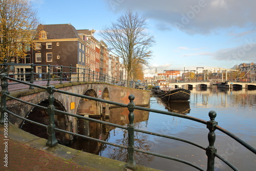 The junction between Amstel river and Prinsengracht Canal, with Skinny Bridge (Magere Brug) in the background, Amsterdam, Netherlands photo