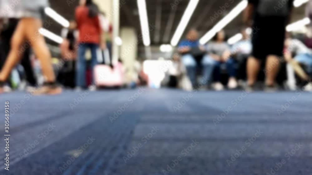 The detailed view of legs walks on carpet in hall, accelerated motion. A blurred passengers on to the airport. The detailed view of legs walks on carpet in hall, accelerated motion. A blurred passengers on to the airport.