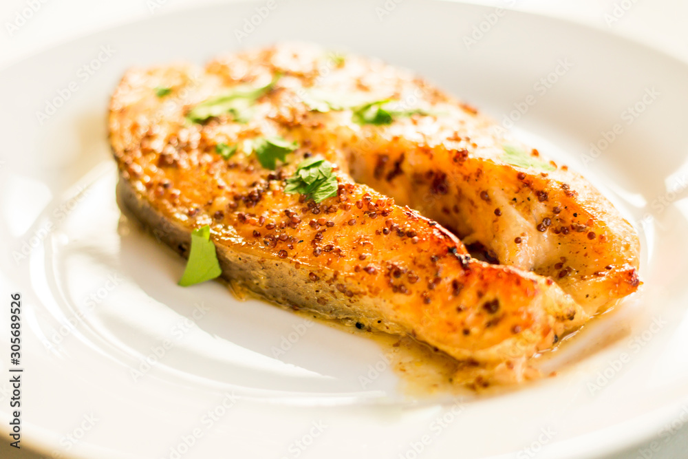 cook salmon in white plate with honey and mustard