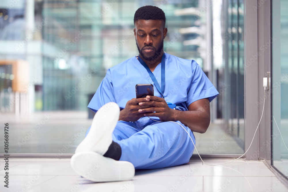© Monkey Business - Male Medical Worker In Hospital Addicted To Using Mobile Phone At Work © Monkey Business - Male Medical Worker In Hospital Addicted To Using Mobile Phone At Work