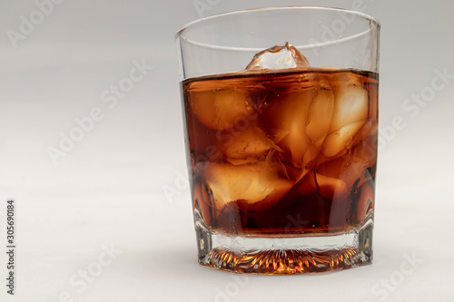 A close up in a glass of cold cola,  isolated white background