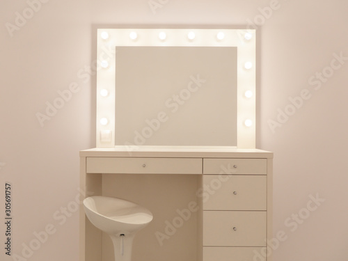 Makeup mirror with gold lights. Photo of the mirror in the make-up room. Backstage dressing room