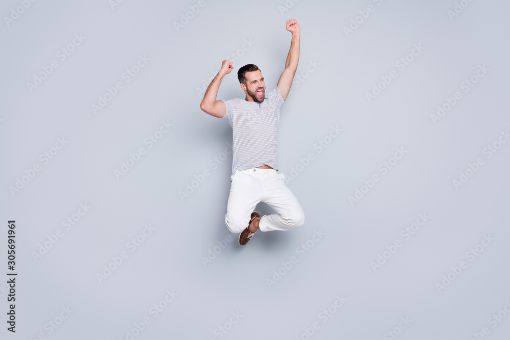 Fototapeta premium Full length body size view of his he nice attractive sportive cheerful cheery glad fit bearded guy jumping up rejoicing isolated over light grey pastel color background