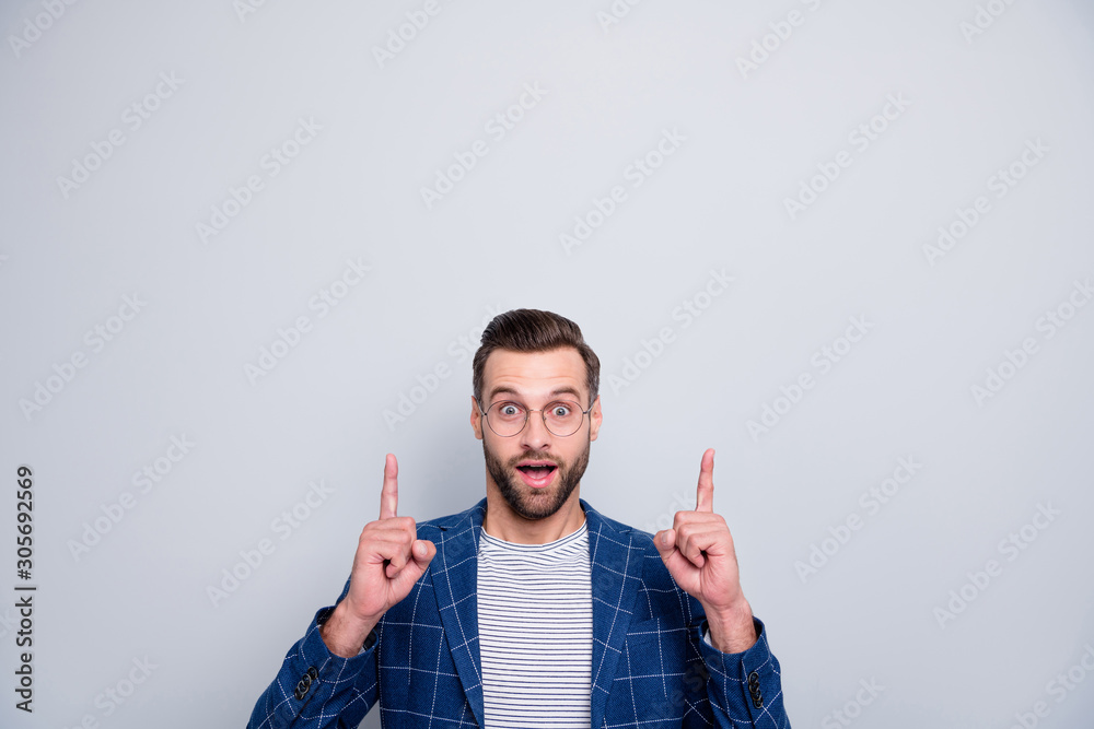Photo of cheerful fun positive creative man with stubble pointing up at empty space for you to see new information isolated over grey color background - obrazy, fototapety, plakaty 
