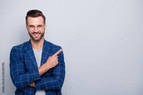 Portrait of his he nice classy attractive well-dressed imposing cheerful cheery glad bearded guy in checked blazer showing copy space ad advert isolated over light grey pastel color background