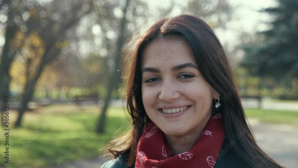 Beautiful brunette girl smiling happily in a park on a sunny day in nice park Beautiful brunette girl smiling happily in a park on a sunny day in nice park