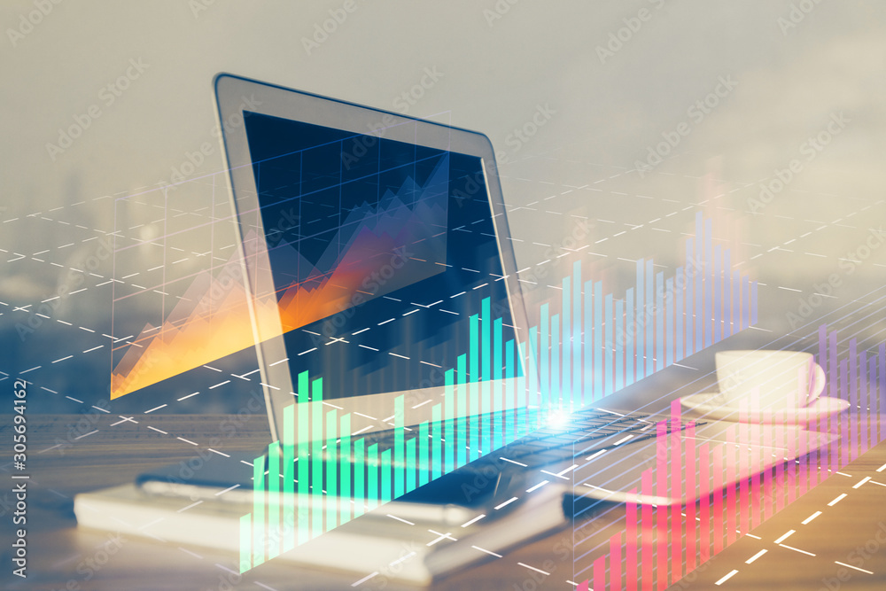 Stock market chart hologram drawn on personal computer background. Multi exposure. Concept of investment. Stock market chart hologram drawn on personal computer background. Multi exposure. Concept of investment.