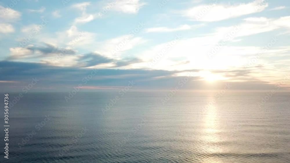 Drone Panning Above A Coastal Beach With White Sandy Shore At Sunrise Drone Panning Above A Coastal Beach With White Sandy Shore At Sunrise