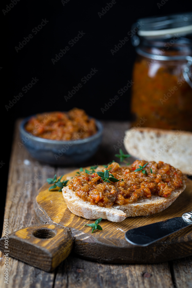 Eggplant dip with bread. Sandwich with eggplant caviar on wooden background Eggplant dip with bread. Sandwich with eggplant caviar on wooden background