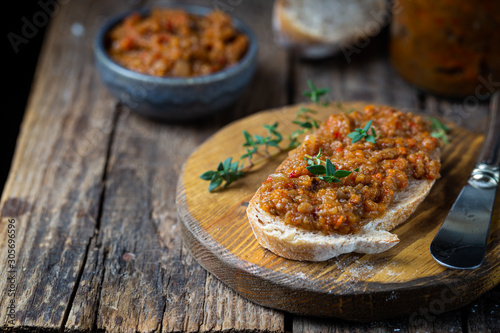 Eggplant dip with bread. Sandwich with eggplant caviar on wooden background