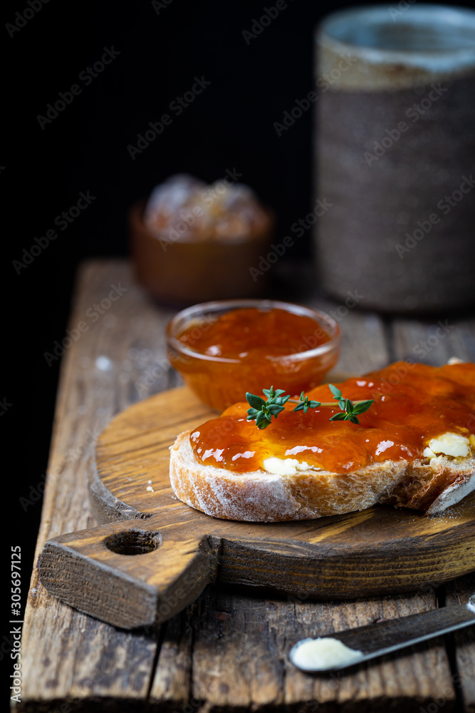 Closeup of pieces of white bread with apricot jam on dark background Closeup of pieces of white bread with apricot jam on dark background