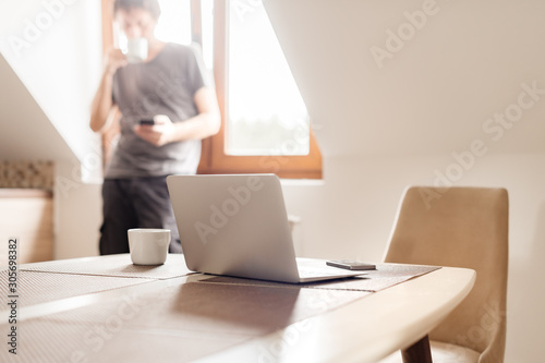 Man telecommuting, coffee break in the morning photo