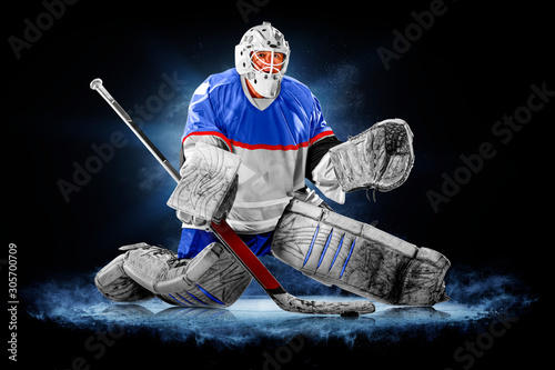 Professional ice hockey goalkeeper or goalie or goaltender isolated on black backgroung